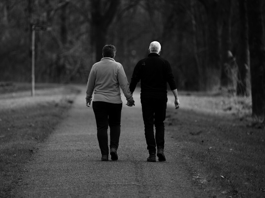 retired couple walking in park