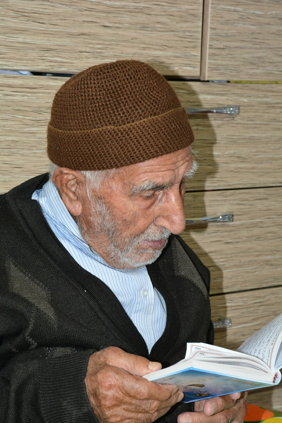elderly man reading book